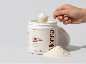Mona Super Collagen powder being scooped out of a container on a light gray background